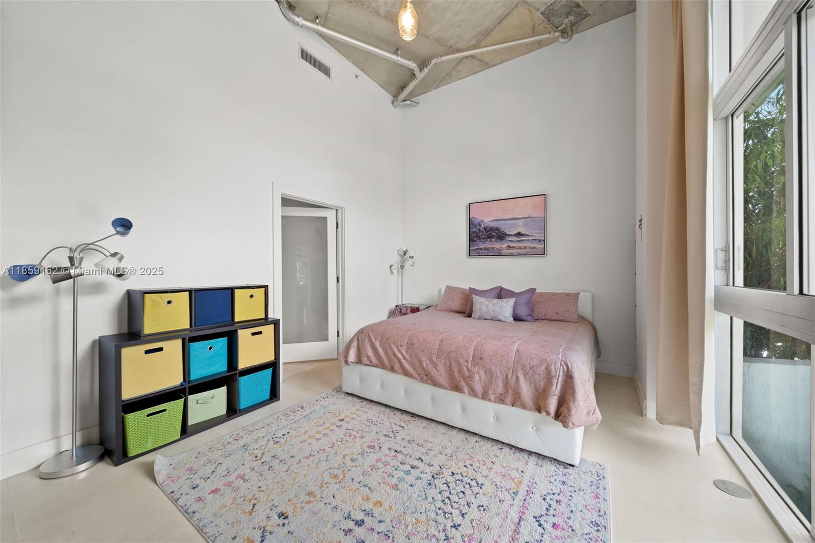 2001 Meridian Avenue, Unit 103 Miami Beach, FL 33139 - Photo 12 of 49 a bedroom with a bed and a painting on the wall