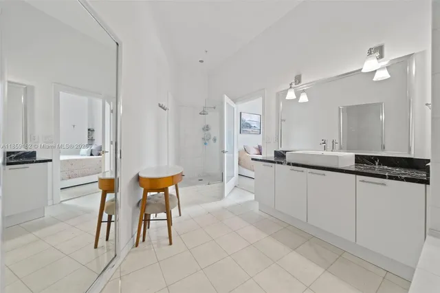 a large white kitchen with a white table and chairs