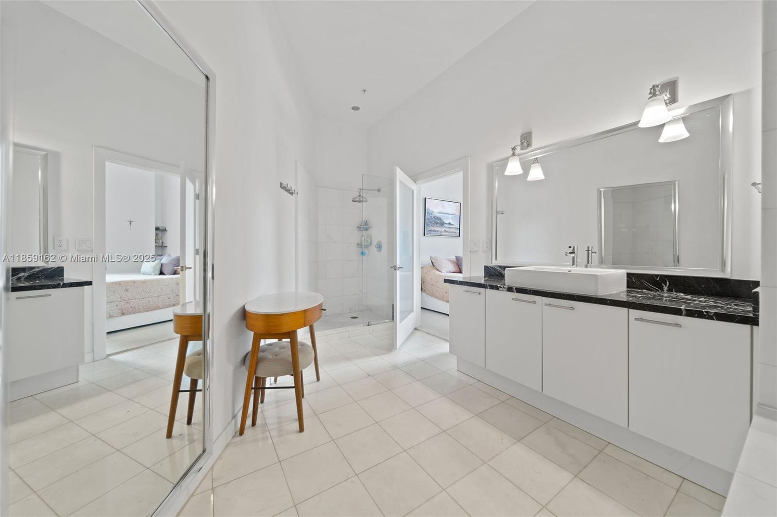 2001 Meridian Avenue, Unit 103 Miami Beach, FL 33139 - Photo 17 of 49 a large white kitchen with a white table and chairs