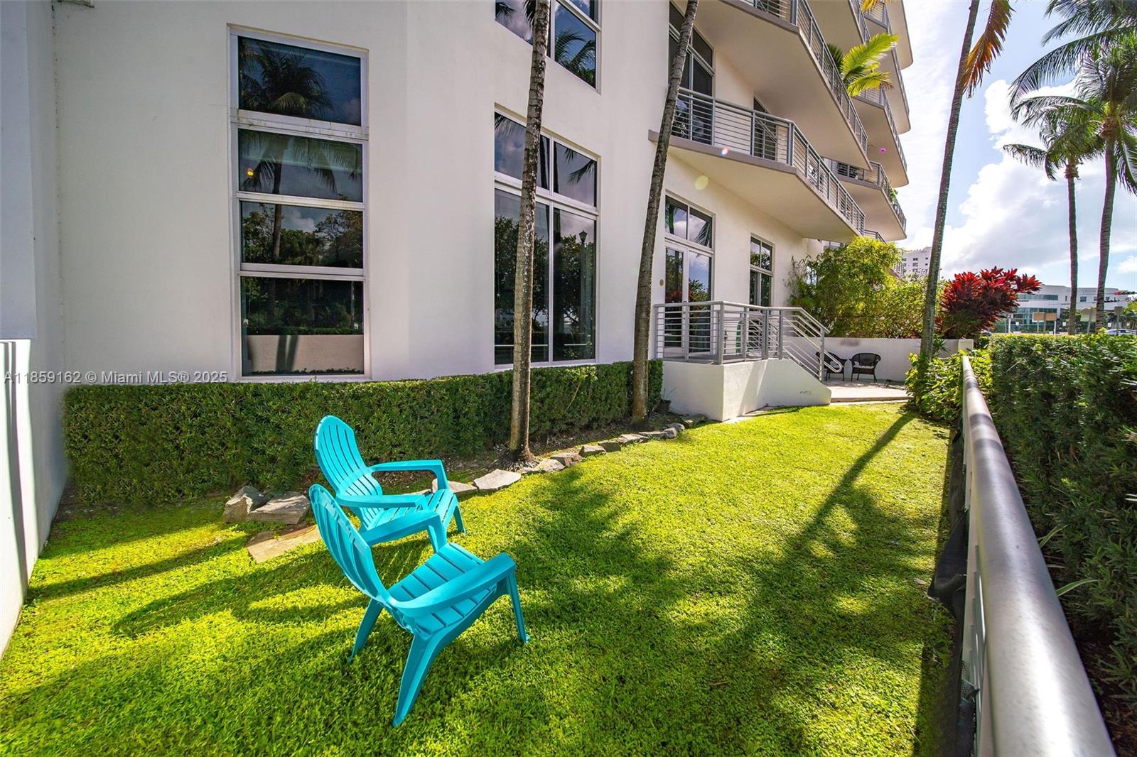 2001 Meridian Avenue, Unit 103 Miami Beach, FL 33139 - Photo 27 of 49 a view of a swimming pool with two chairs in a yard