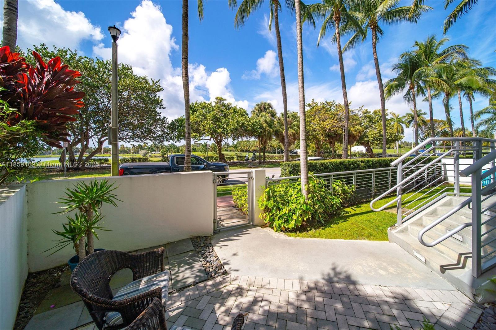 2001 Meridian Avenue, Unit 103 Miami Beach, FL 33139 - Photo 30 of 49 a view of a swimming pool with a yard and palm trees