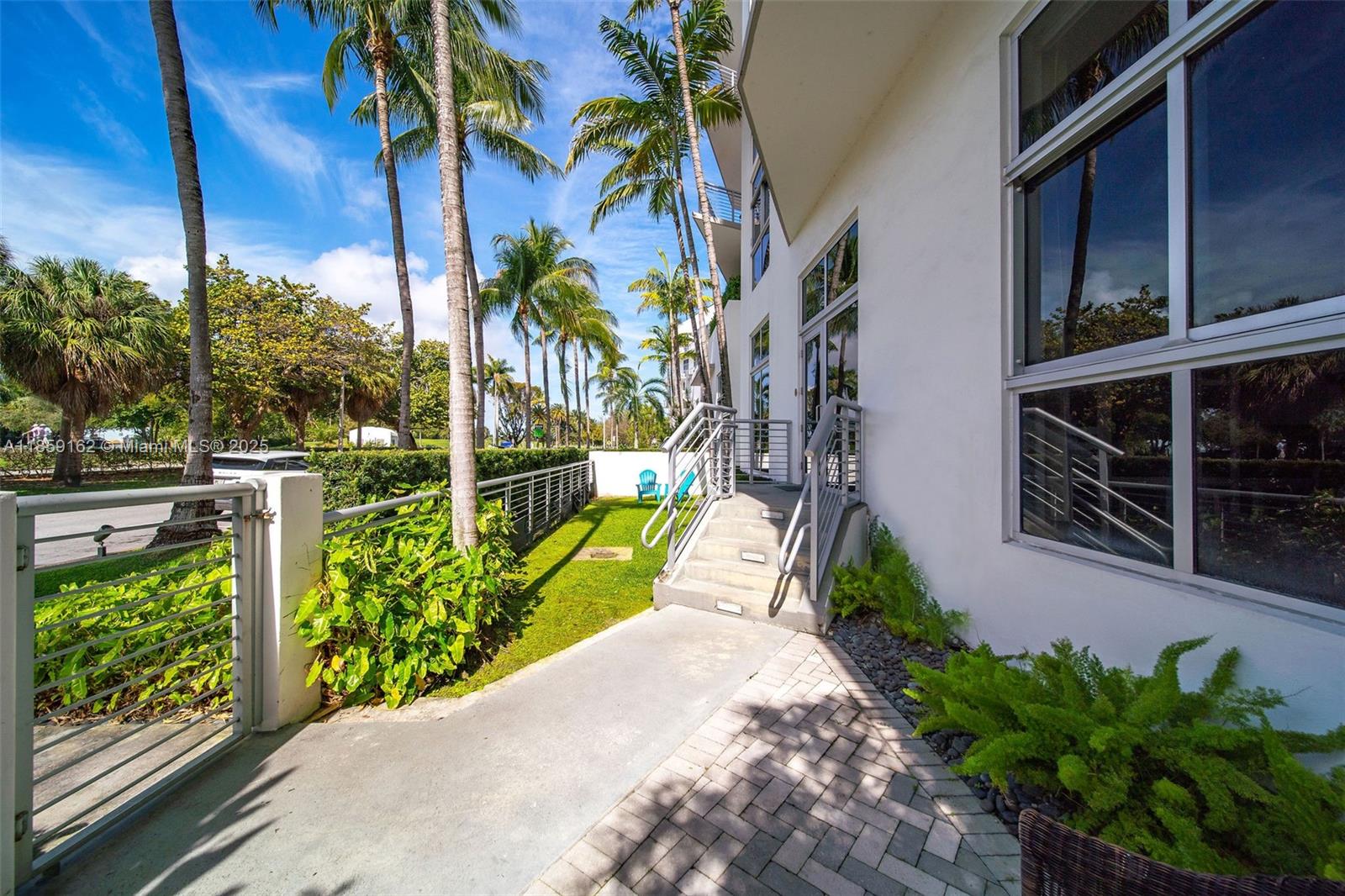 2001 Meridian Avenue, Unit 103 Miami Beach, FL 33139 - Photo 31 of 49 a view of a garden with a building in the background