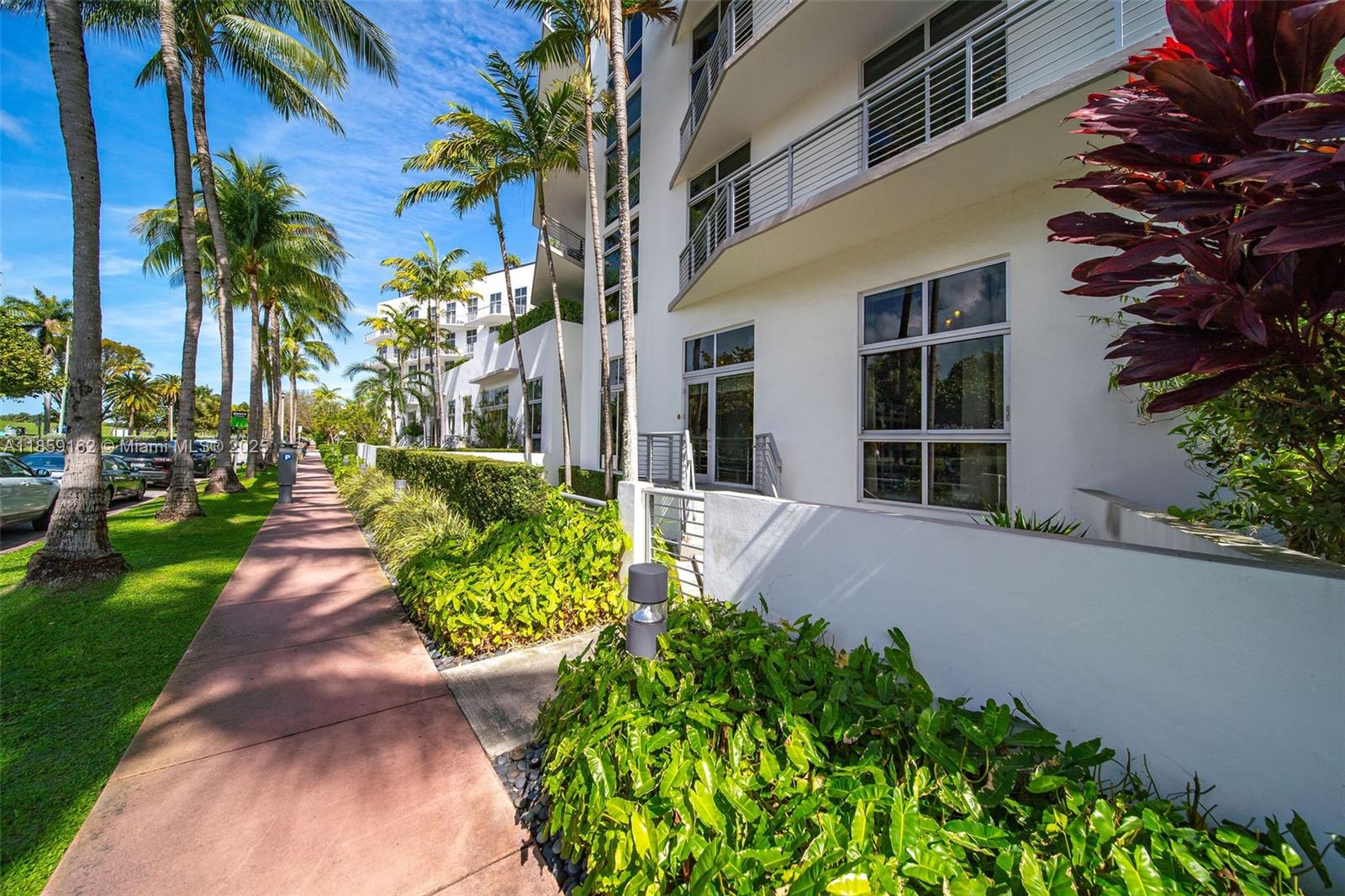 2001 Meridian Avenue, Unit 103 Miami Beach, FL 33139 - Photo 34 of 49 a front view of a house with a yard and potted plants