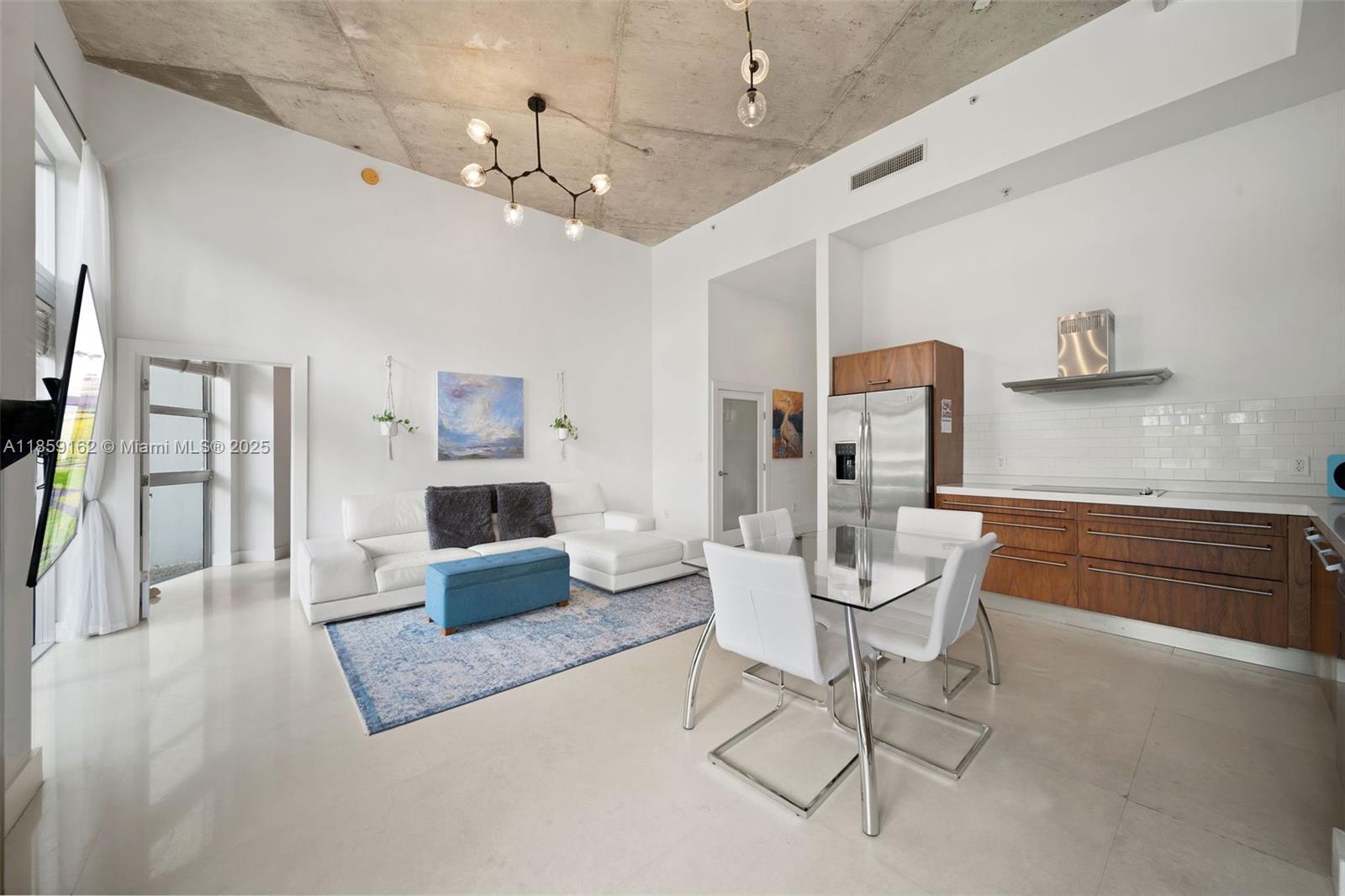 2001 Meridian Avenue, Unit 103 Miami Beach, FL 33139 - Photo 7 of 49 a living room with furniture and a chandelier