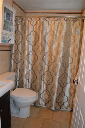33 Edgewood Road Holbrook, MA 02343 - Photo 12 of 24 a white toilet sitting next to a shower curtain