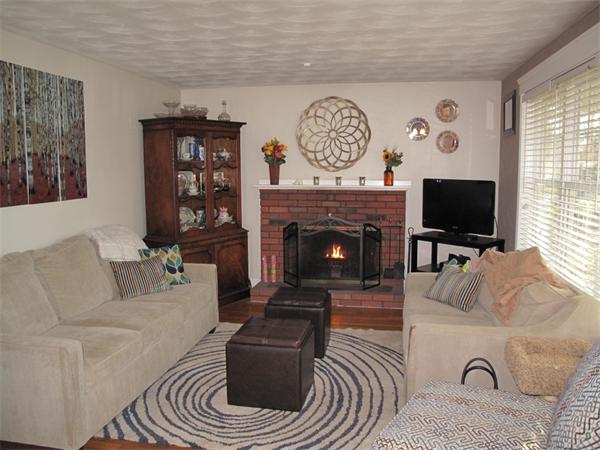 33 Edgewood Road Holbrook, MA 02343 - Photo 4 of 24 a living room with furniture a flat screen tv and a fireplace