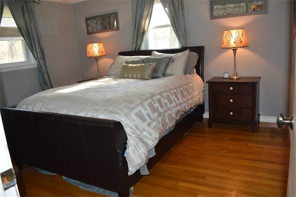 33 Edgewood Road Holbrook, MA 02343 - Photo 9 of 24 a bed sitting in a bedroom next to a lamp next to a window