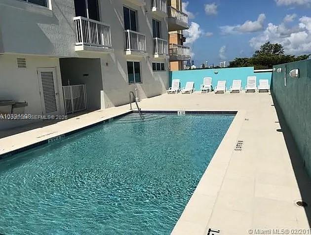 2400 Southwest 27th Avenue, Unit 304 Miami, FL 33145 - Photo 17 of 18 a view of a swimming pool with a patio