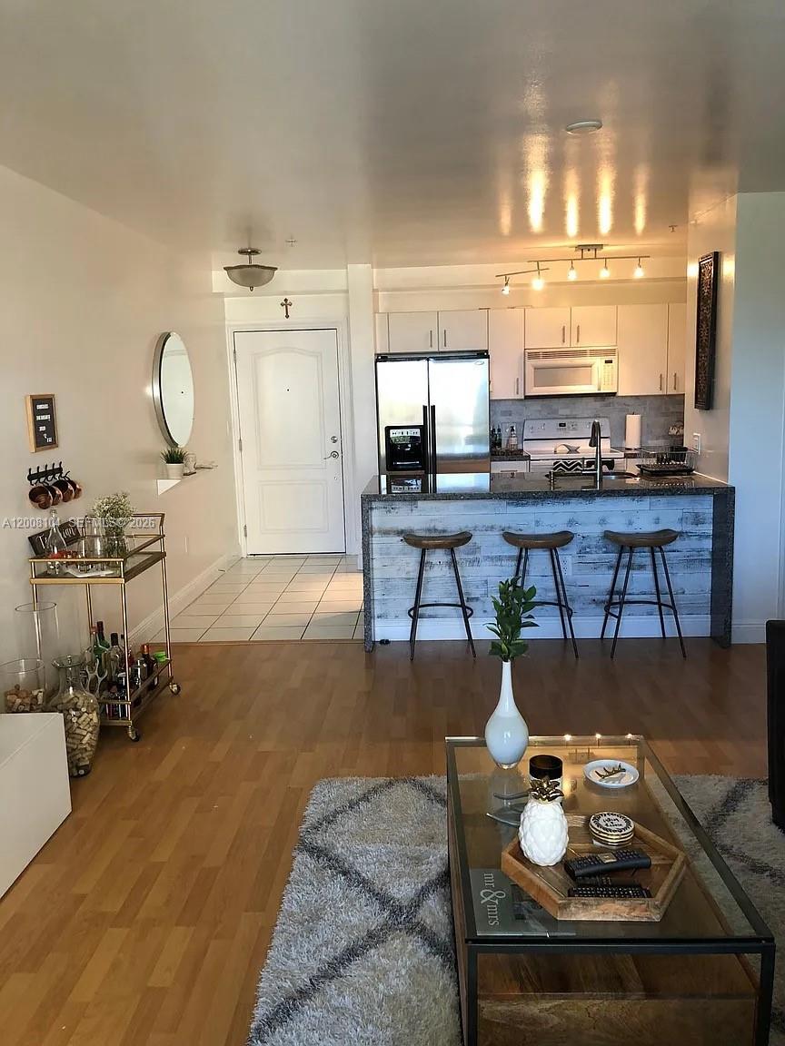 2400 Southwest 27th Avenue, Unit 304 Miami, FL 33145 - Photo 2 of 18 a living room with furniture and view of kitchen