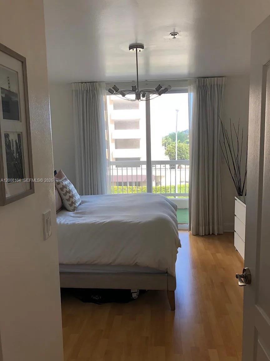 2400 Southwest 27th Avenue, Unit 304 Miami, FL 33145 - Photo 7 of 18 a bedroom with a bed and a window