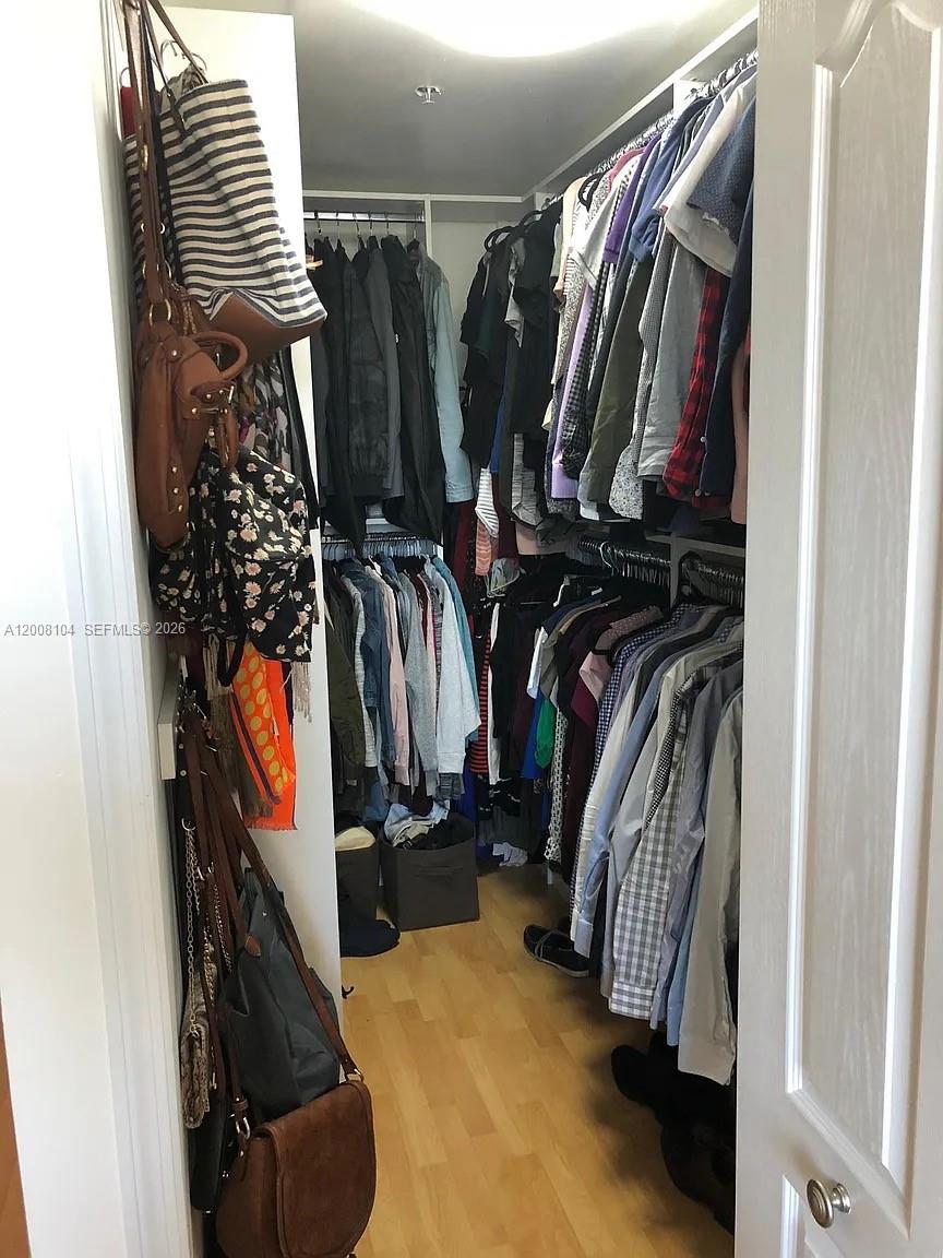 2400 Southwest 27th Avenue, Unit 304 Miami, FL 33145 - Photo 10 of 18 a view of walk in closet with clothes and shoes