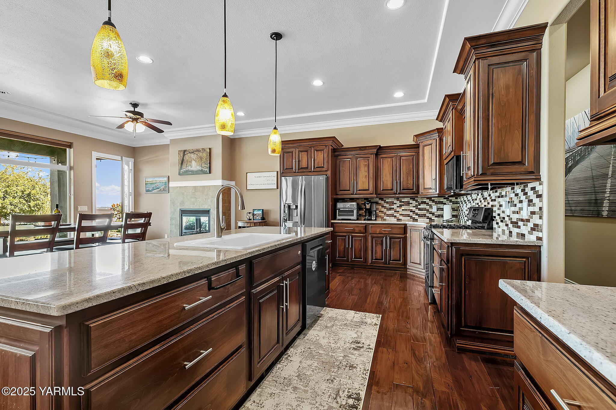7501 Crestfields Road Yakima, WA 98903 - Photo 16 of 38 a kitchen with stainless steel appliances granite countertop a stove refrigerator and cabinets