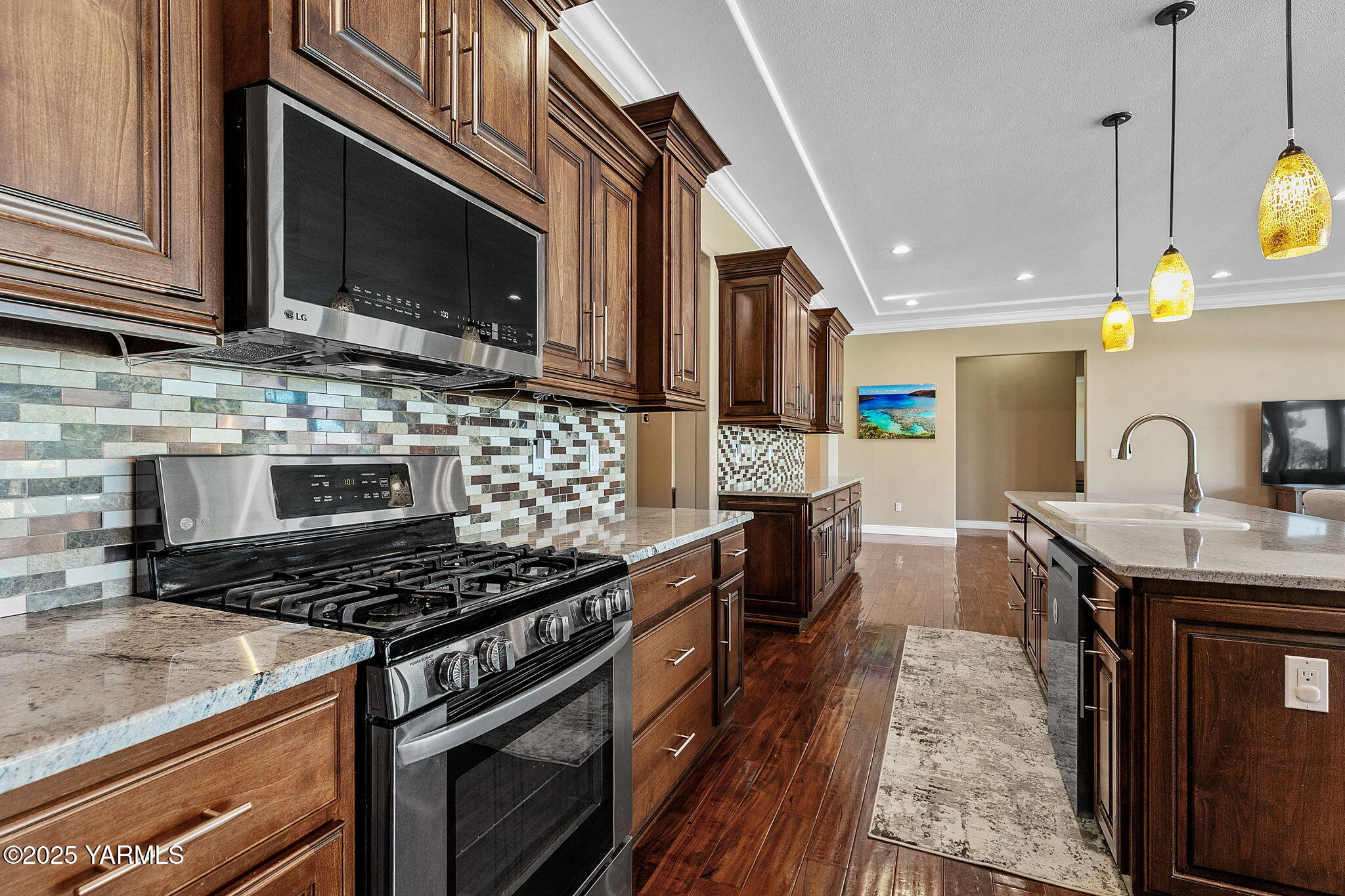 7501 Crestfields Road Yakima, WA 98903 - Photo 18 of 38 a kitchen with stainless steel appliances granite countertop a stove a sink and a microwave