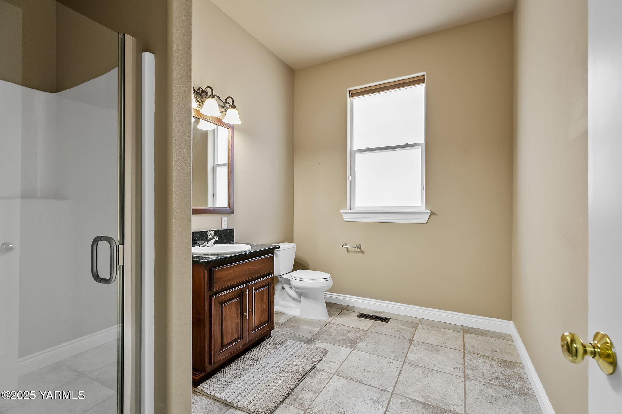 7501 Crestfields Road Yakima, WA 98903 - Photo 30 of 38 a bathroom with a granite countertop sink a toilet and a mirror