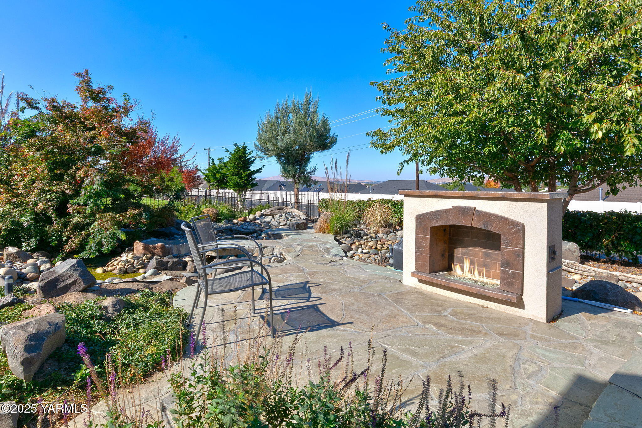 7501 Crestfields Road Yakima, WA 98903 - Photo 35 of 38 a view of a patio with a fireplace and a potted plant