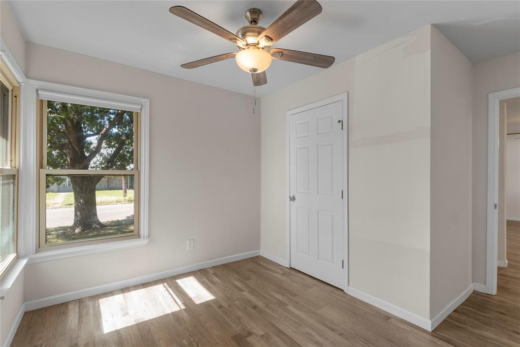 2221 North Alexander Street Sherman, TX 75092 - Photo 13 of 39 a view of an empty room with a window and wooden floor