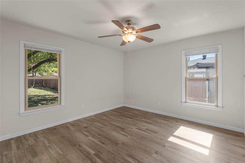 2221 North Alexander Street Sherman, TX 75092 - Photo 16 of 39 a view of an empty room with wooden floor and a window