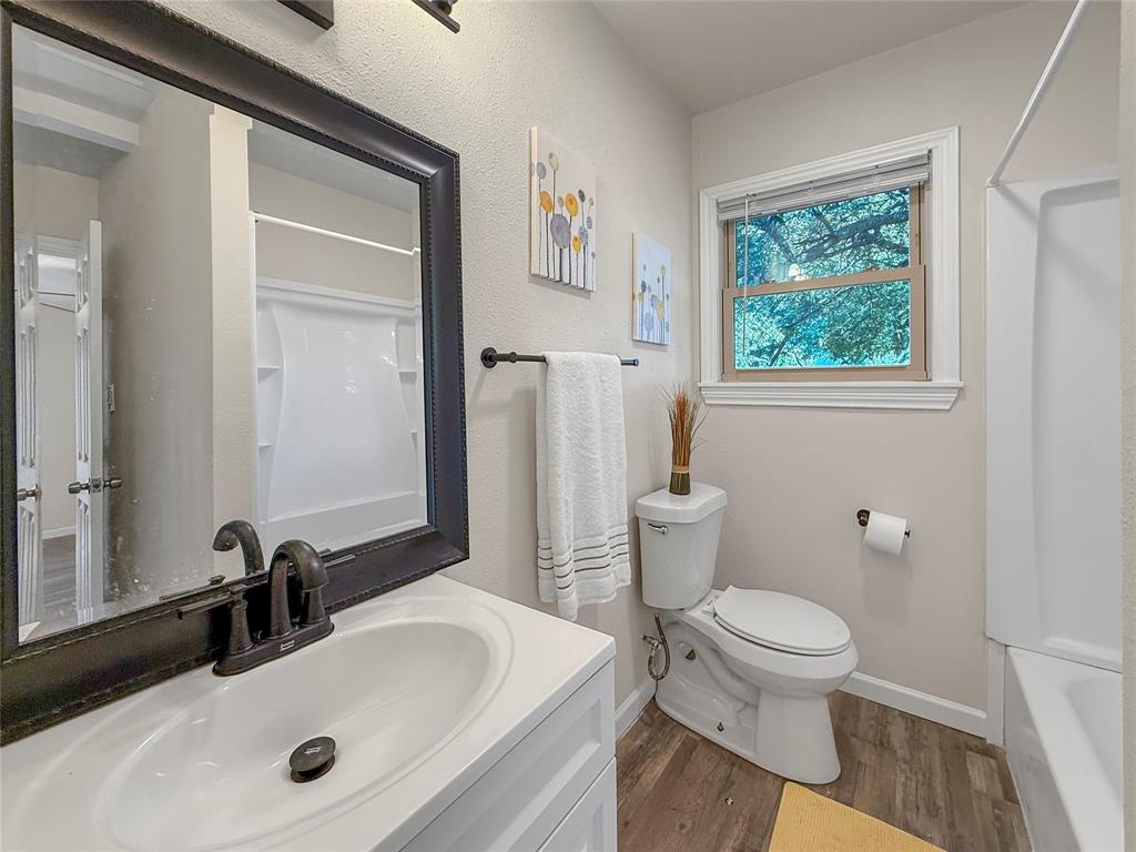 2221 North Alexander Street Sherman, TX 75092 - Photo 18 of 39 a bathroom with a sink and a toilet