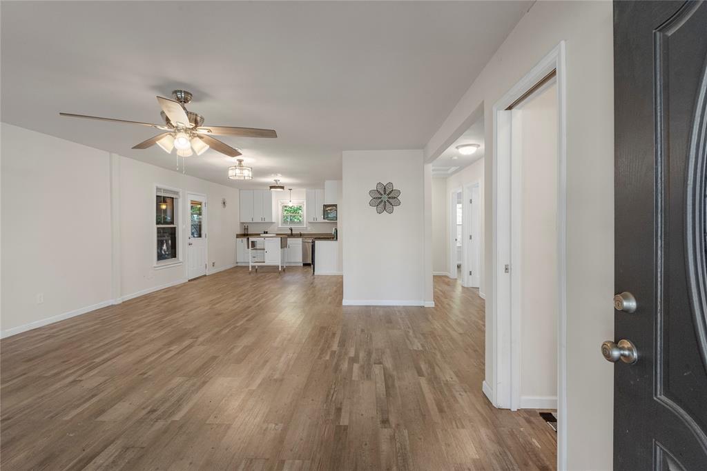 2221 North Alexander Street Sherman, TX 75092 - Photo 3 of 39 wooden floor in an empty room with a window