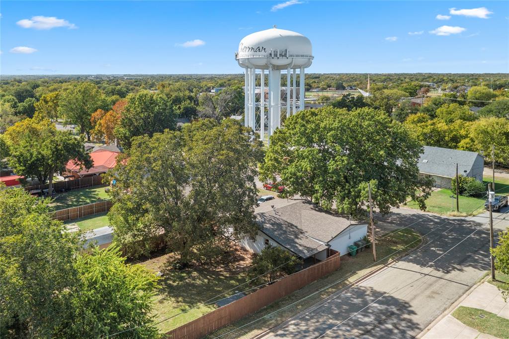 2221 North Alexander Street Sherman, TX 75092 - Photo 36 of 39 a view of a yard with table and chairs and potted plants