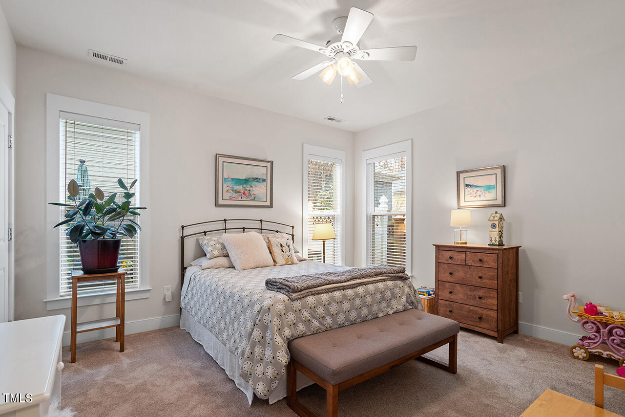 4526 All Points View Way Raleigh, NC 27614 - Photo 12 of 25 a bedroom with a bed a dresser and potted plant