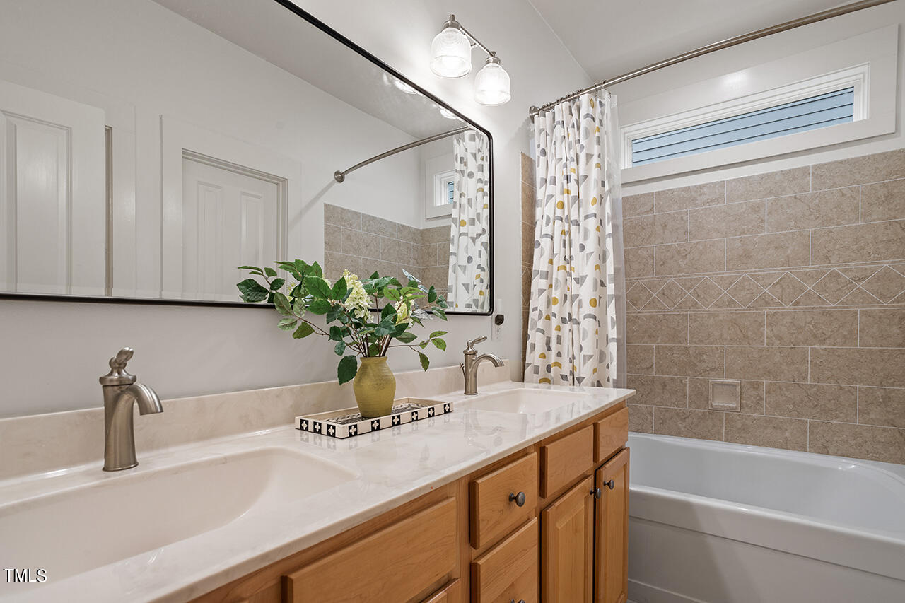 4526 All Points View Way Raleigh, NC 27614 - Photo 13 of 25 a bathroom with a granite countertop sink a mirror and a shower
