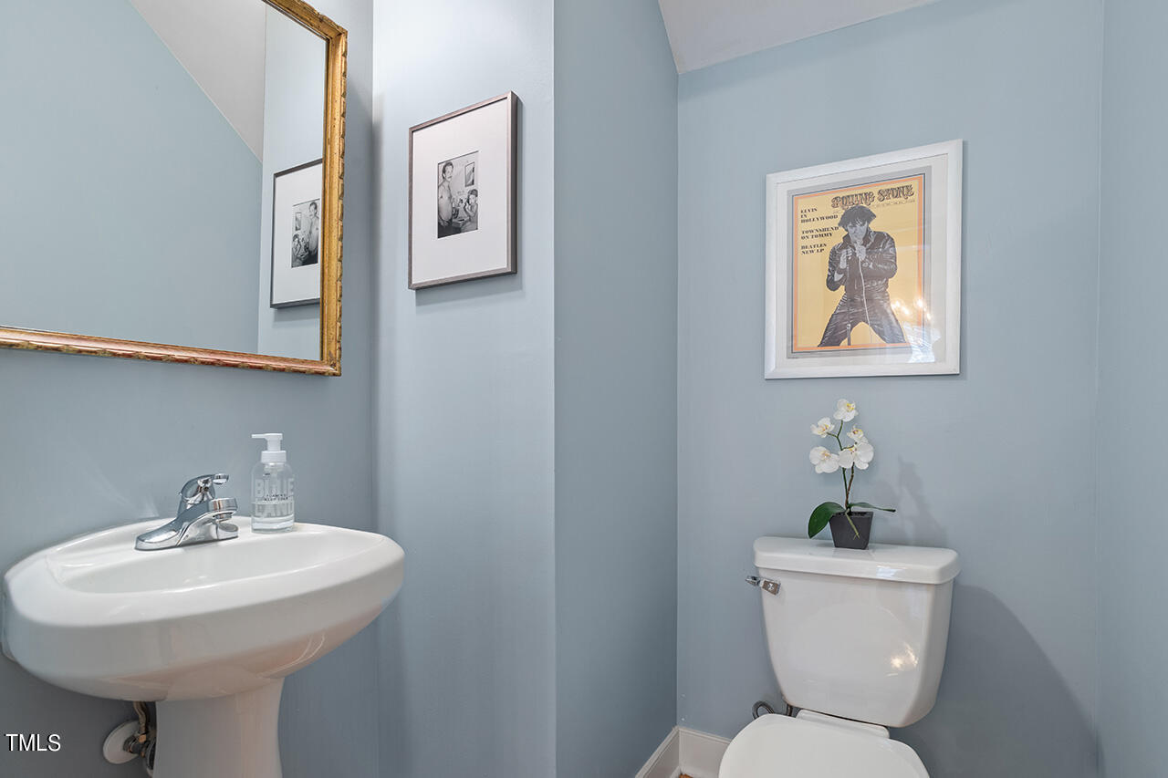 4526 All Points View Way Raleigh, NC 27614 - Photo 14 of 25 a bathroom with a toilet a sink and mirror