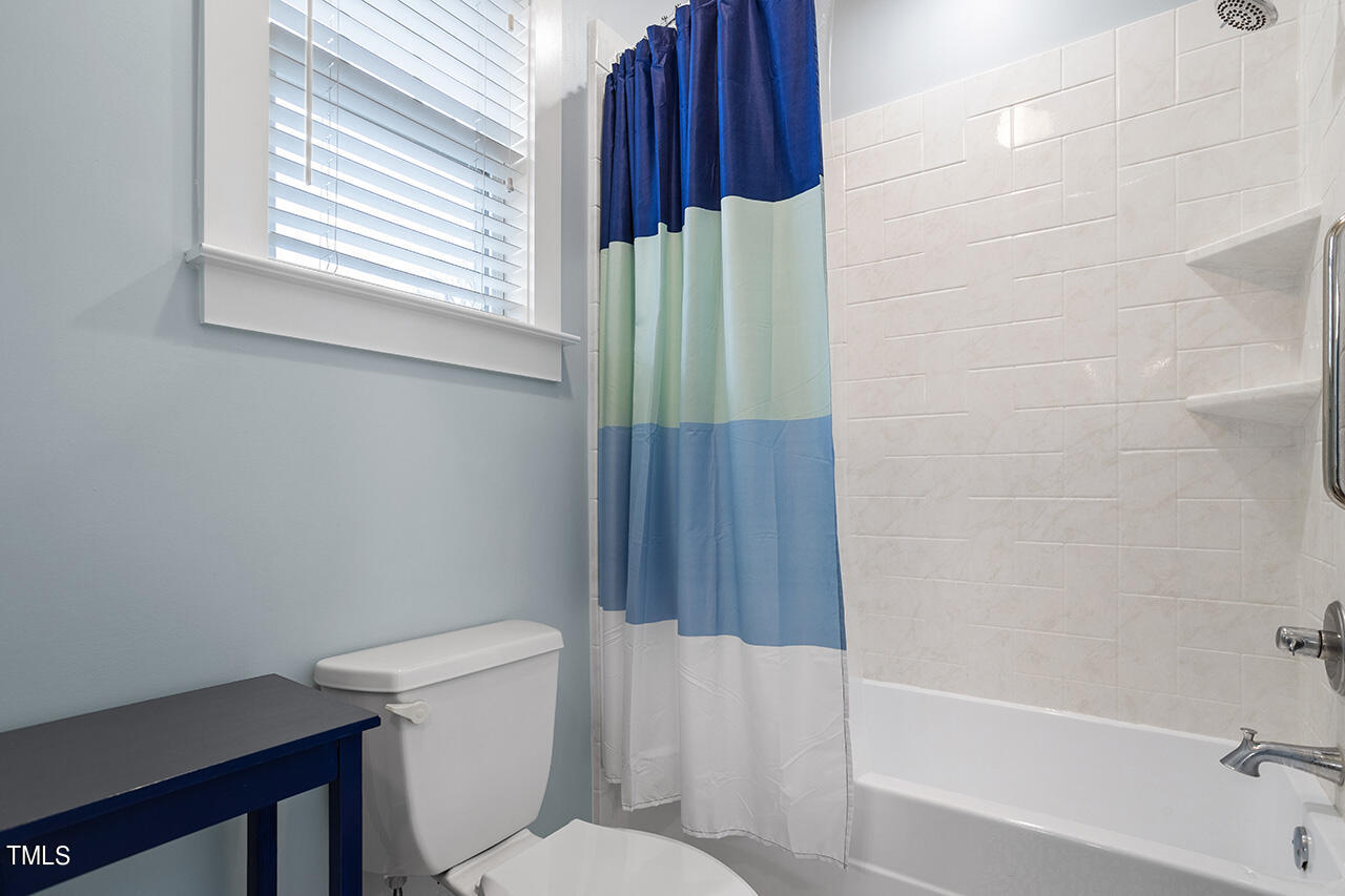 4526 All Points View Way Raleigh, NC 27614 - Photo 19 of 25 a bathroom with a toilet and a shower curtain
