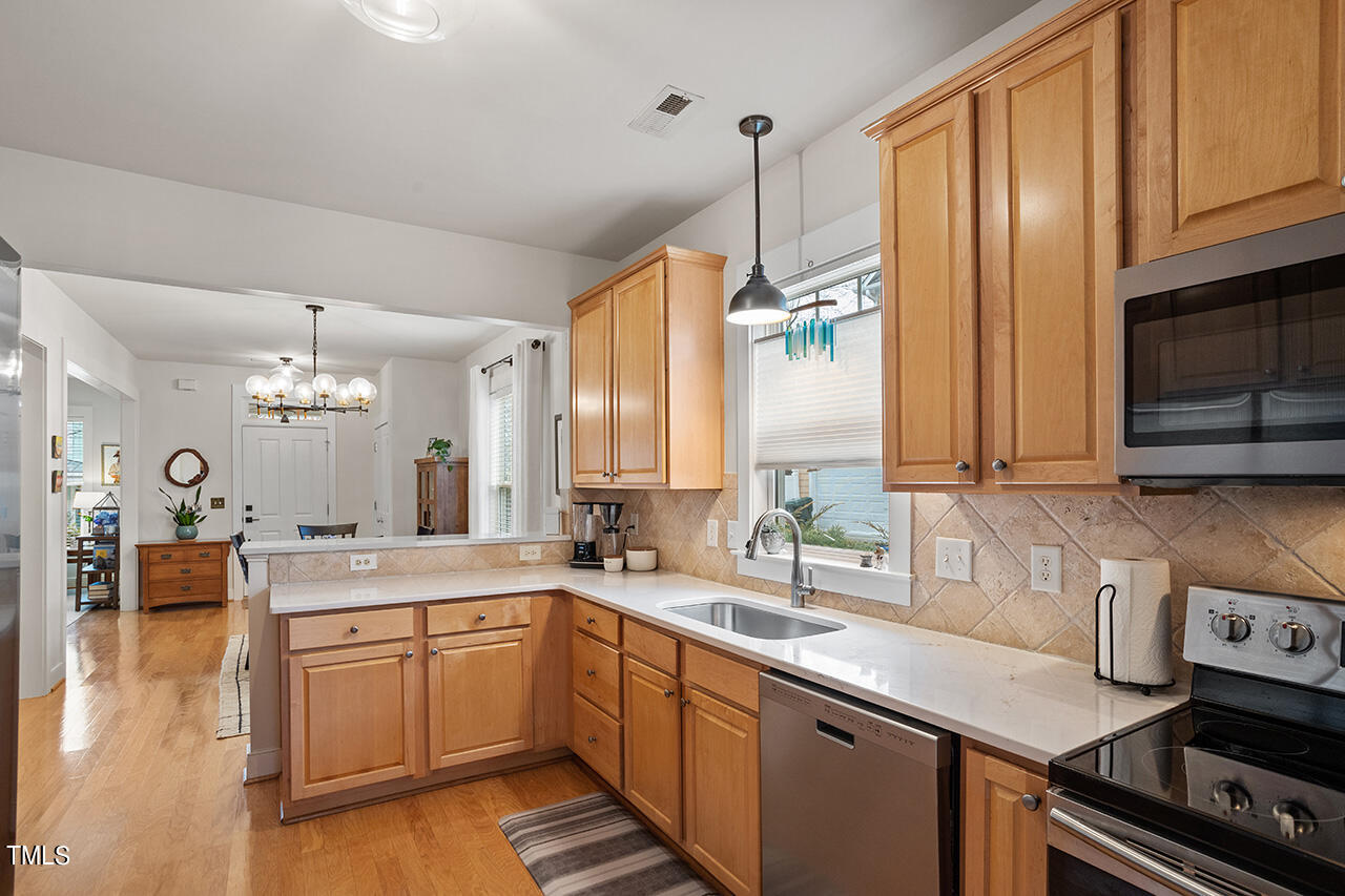 4526 All Points View Way Raleigh, NC 27614 - Photo 8 of 25 a kitchen with stainless steel appliances granite countertop a sink stove and cabinets