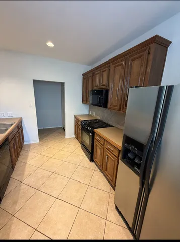 a kitchen with stainless steel appliances a refrigerator sink and stove