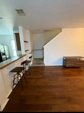 a view of a room with wooden floor