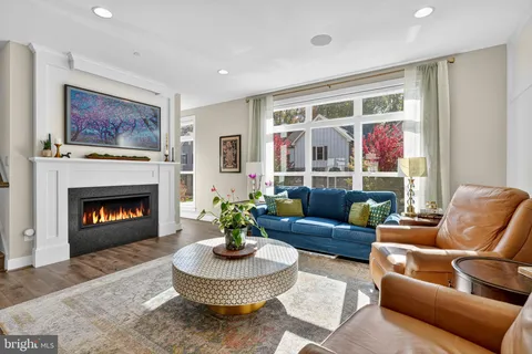 a living room with furniture a fireplace and a window
