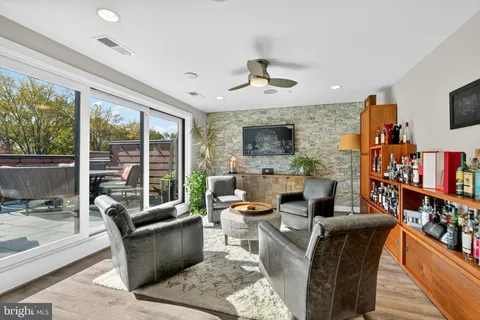 a living room with fireplace furniture and a flat screen tv