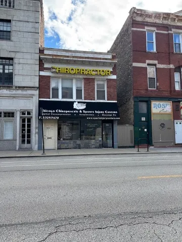 a front view of a building with a garden