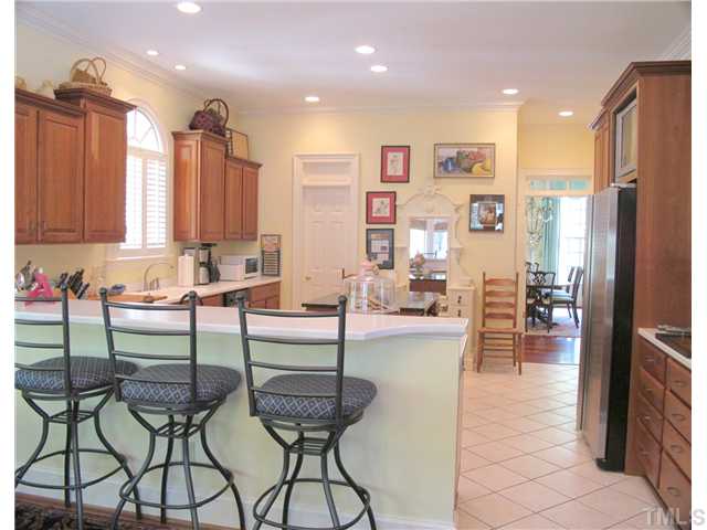 304 Marlowe Road Raleigh, NC 27609 - Photo 13 of 25 a kitchen with stainless steel appliances kitchen island granite countertop a refrigerator a stove top oven and a sink with island