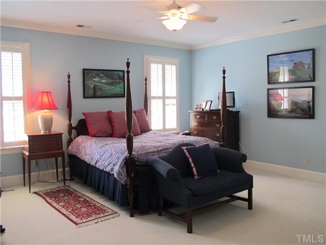 304 Marlowe Road Raleigh, NC 27609 - Photo 22 of 25 a bedroom with a bed lamp and paintings on the wall
