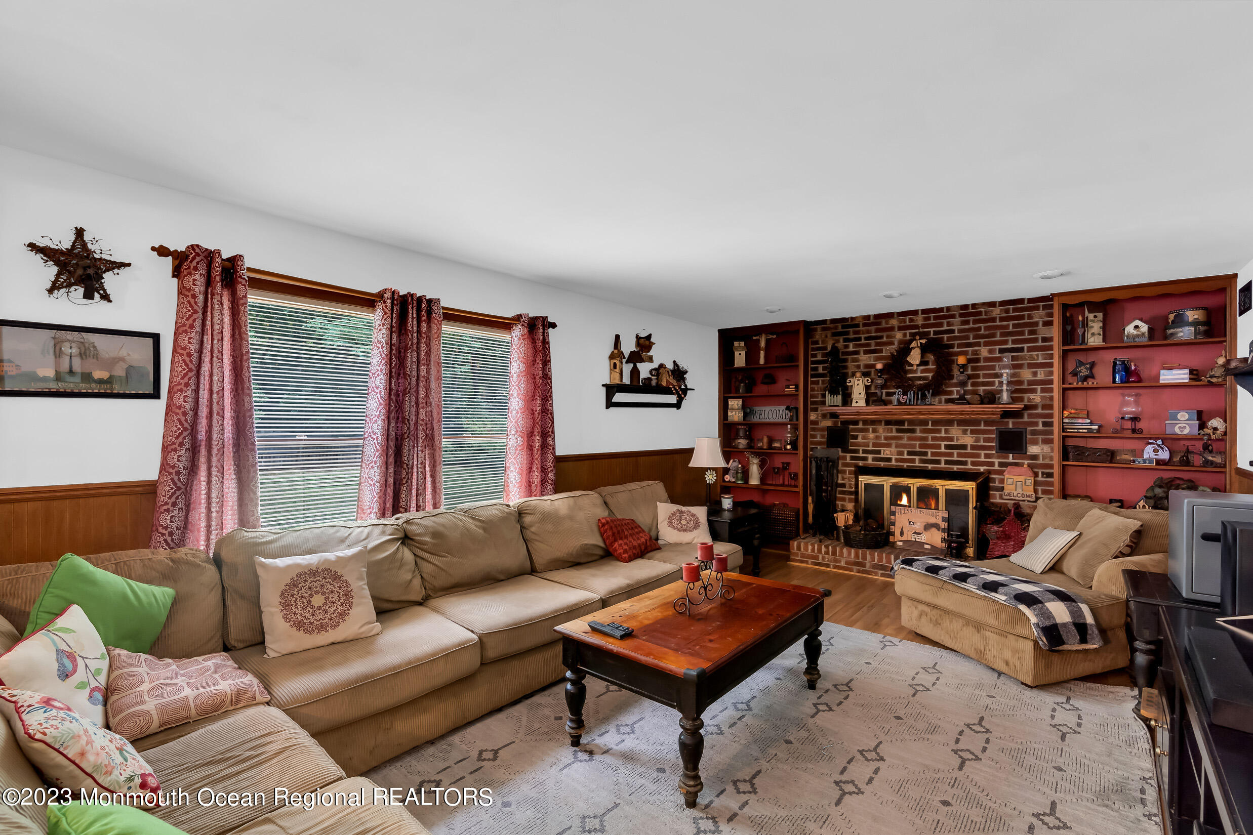 1216 Andover Road Brick, NJ 08724 - Photo 19 of 50 a living room with furniture a rug and a fireplace