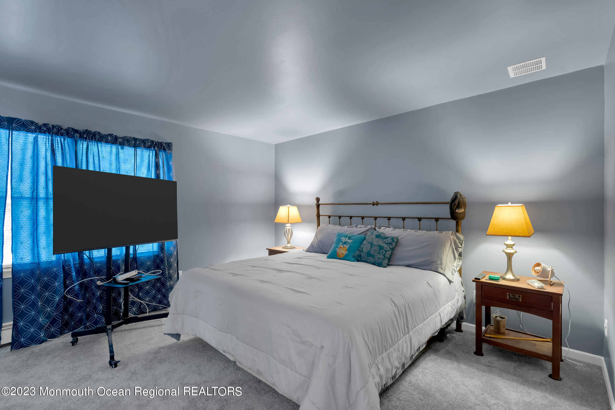 1216 Andover Road Brick, NJ 08724 - Photo 31 of 50 a bedroom with a bed a couch and a flat screen tv