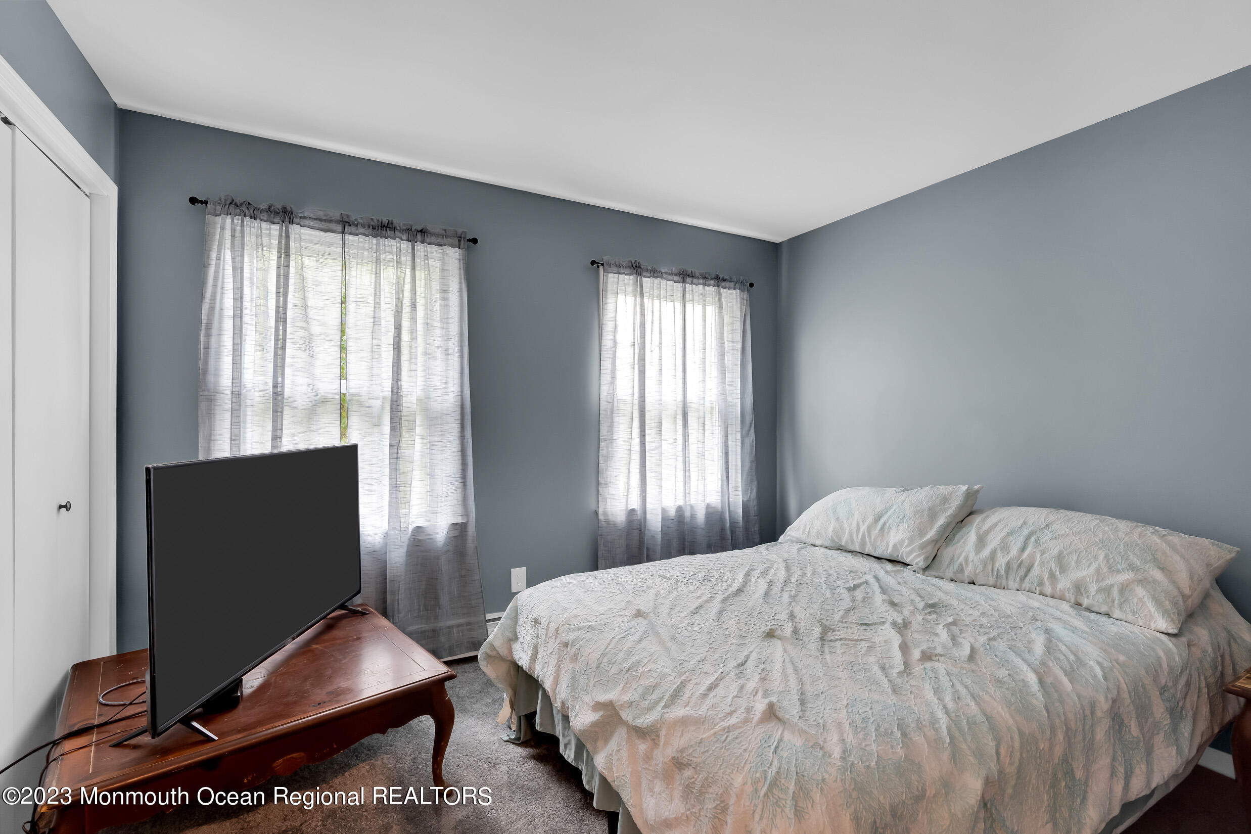 1216 Andover Road Brick, NJ 08724 - Photo 34 of 50 a bedroom with a bed and a flat screen tv