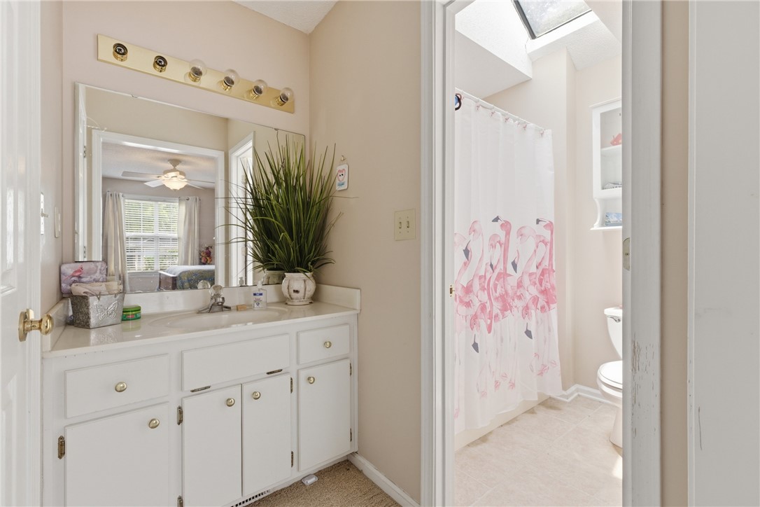 128 Kelly Lane Easley, SC 29642 - Photo 18 of 23 A well-lit bathroom offers a practical vanity with ample storage and a refreshing shower space.