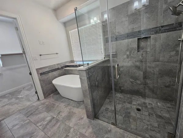 a bathroom with a granite countertop sink a toilet and shower