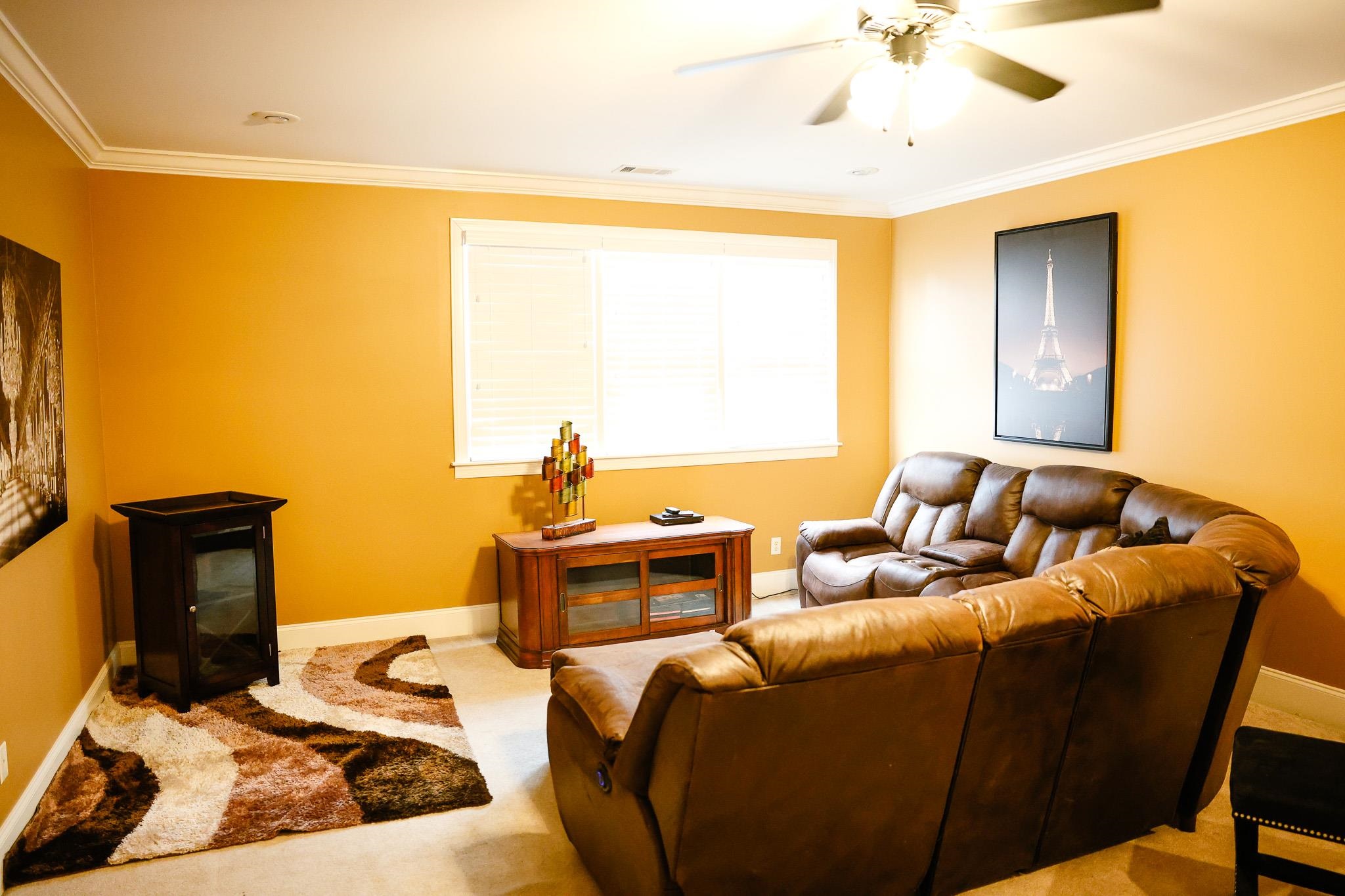 649 Ridge Springs Road Collierville, TN 38017 - Photo 29 of 35 Carpeted living area with ornamental molding and a ceiling fan