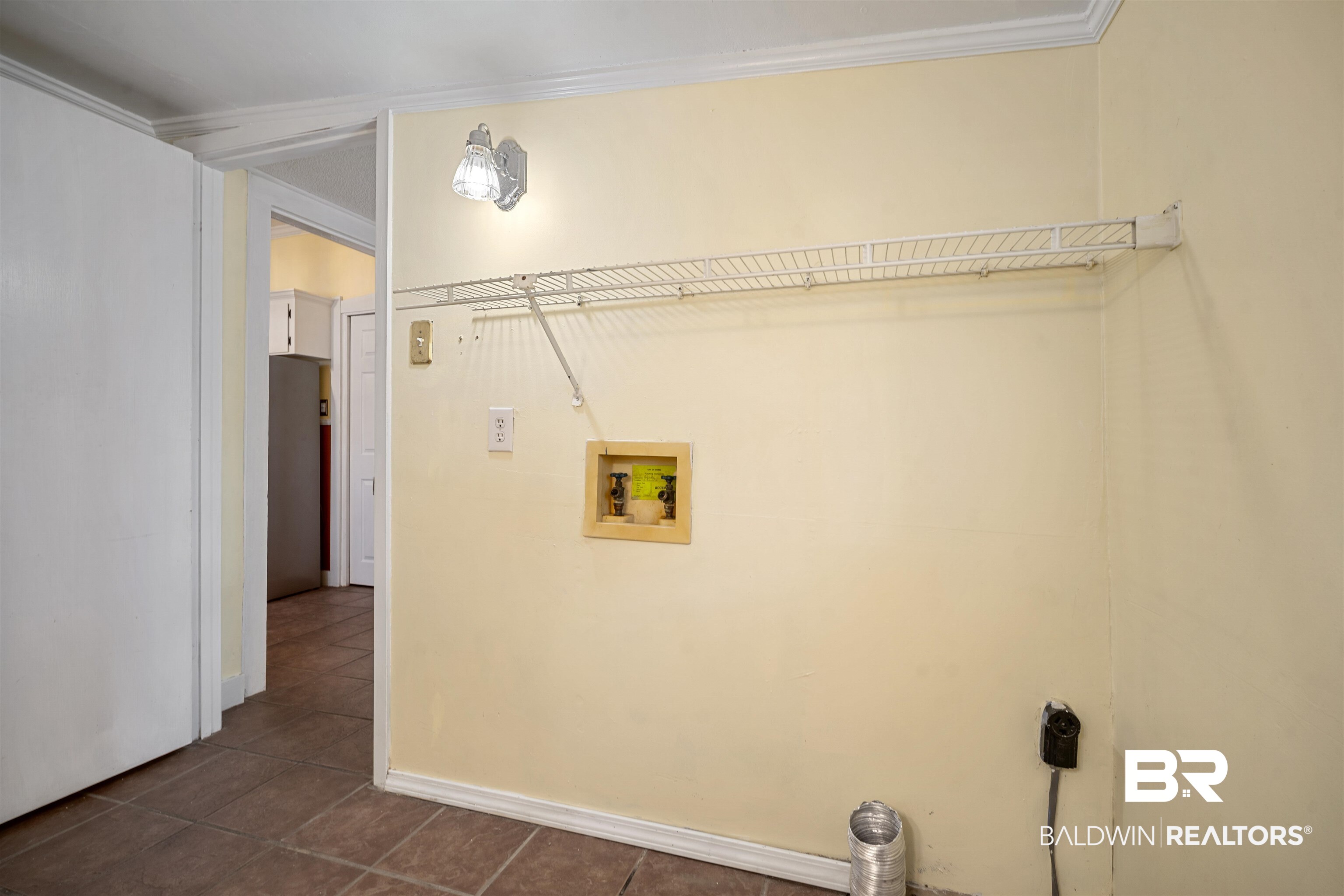 118 Mohawk Street Mobile, AL 36606 - Photo 22 of 26 Laundry room with dark tile patterned floors, hookup for a washing machine, and hookup for an electric dryer