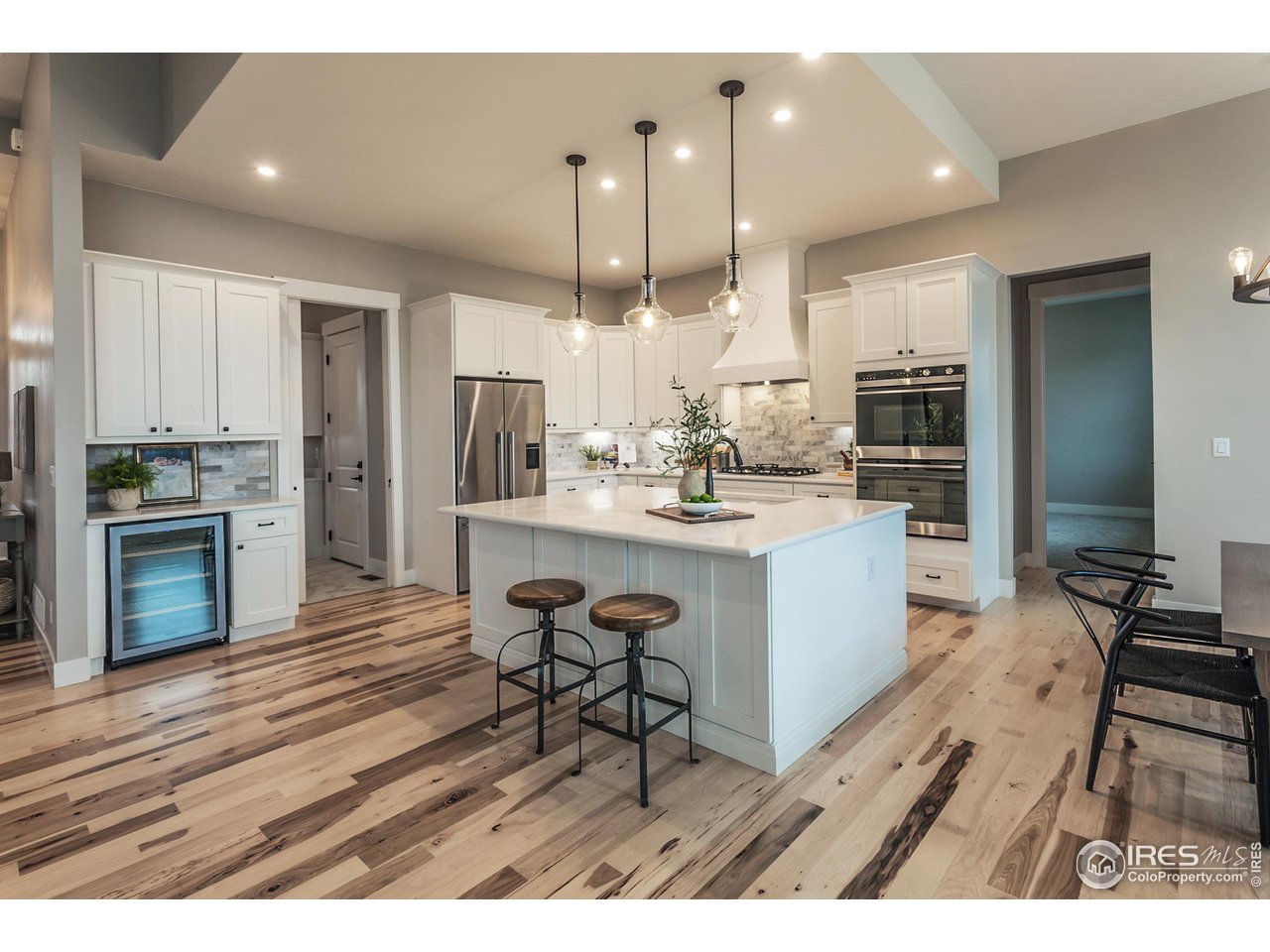 1293 Burt Avenue Berthoud, CO 80513 - Photo 13 of 40 a open kitchen with kitchen island a sink stove and refrigerator