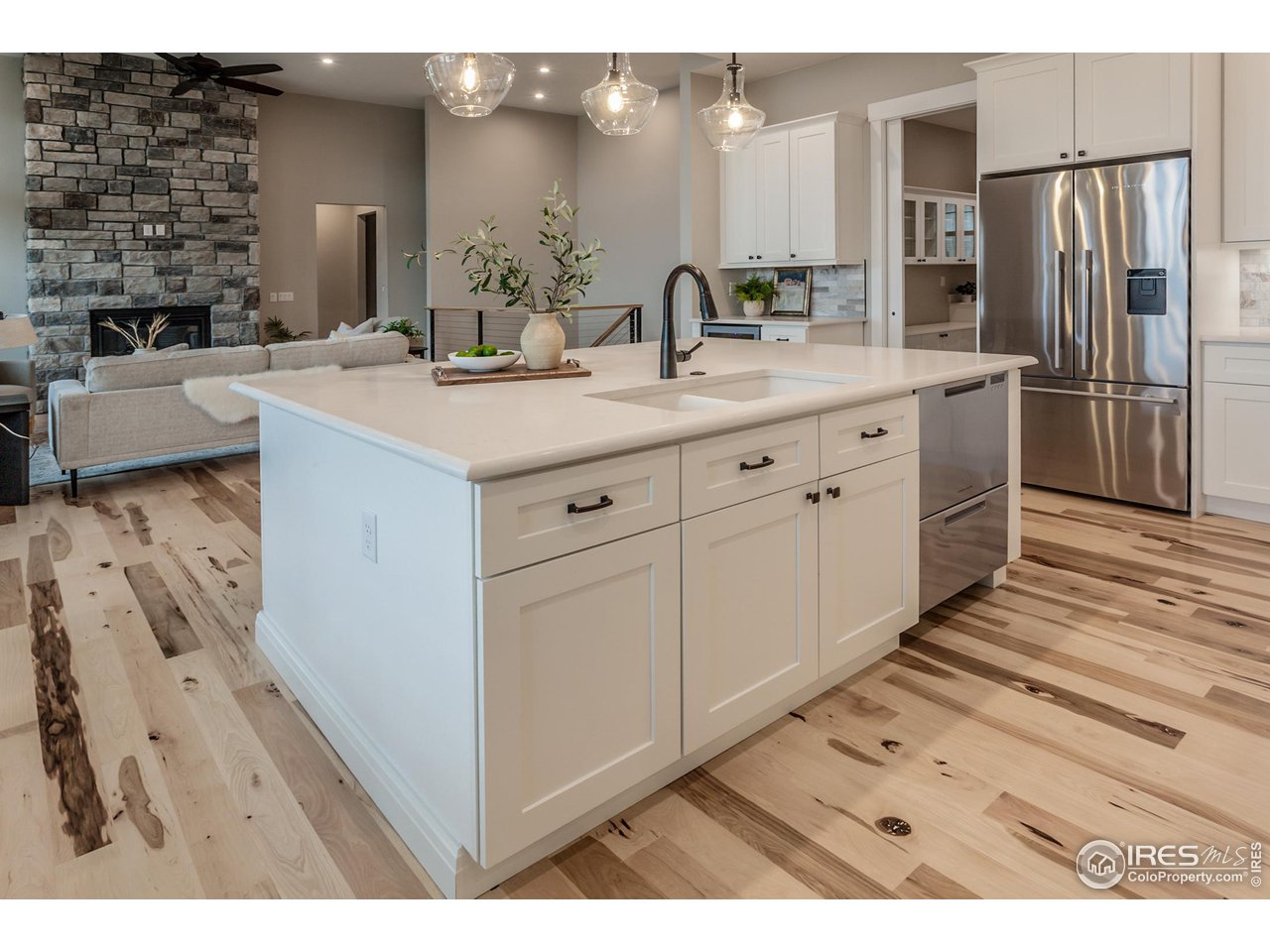 1293 Burt Avenue Berthoud, CO 80513 - Photo 15 of 40 a bathroom with a double vanity sink a mirror and a shower