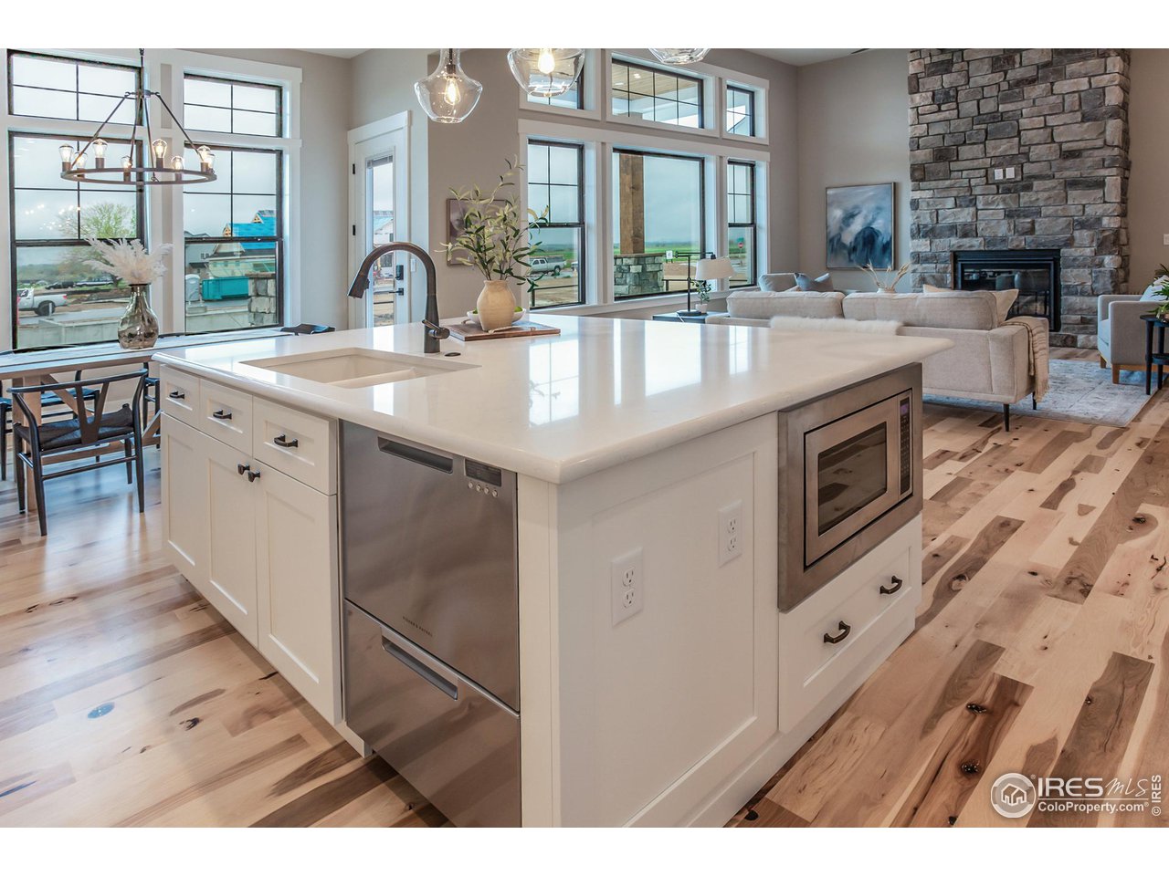 1293 Burt Avenue Berthoud, CO 80513 - Photo 16 of 40 a kitchen with kitchen island granite countertop a stove and a sink
