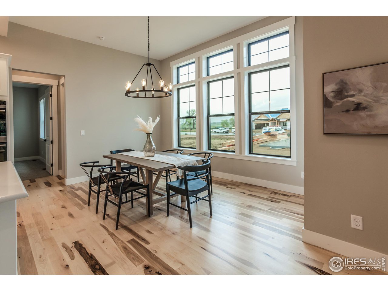 1293 Burt Avenue Berthoud, CO 80513 - Photo 20 of 40 a dining room with furniture a chandelier and wooden floor