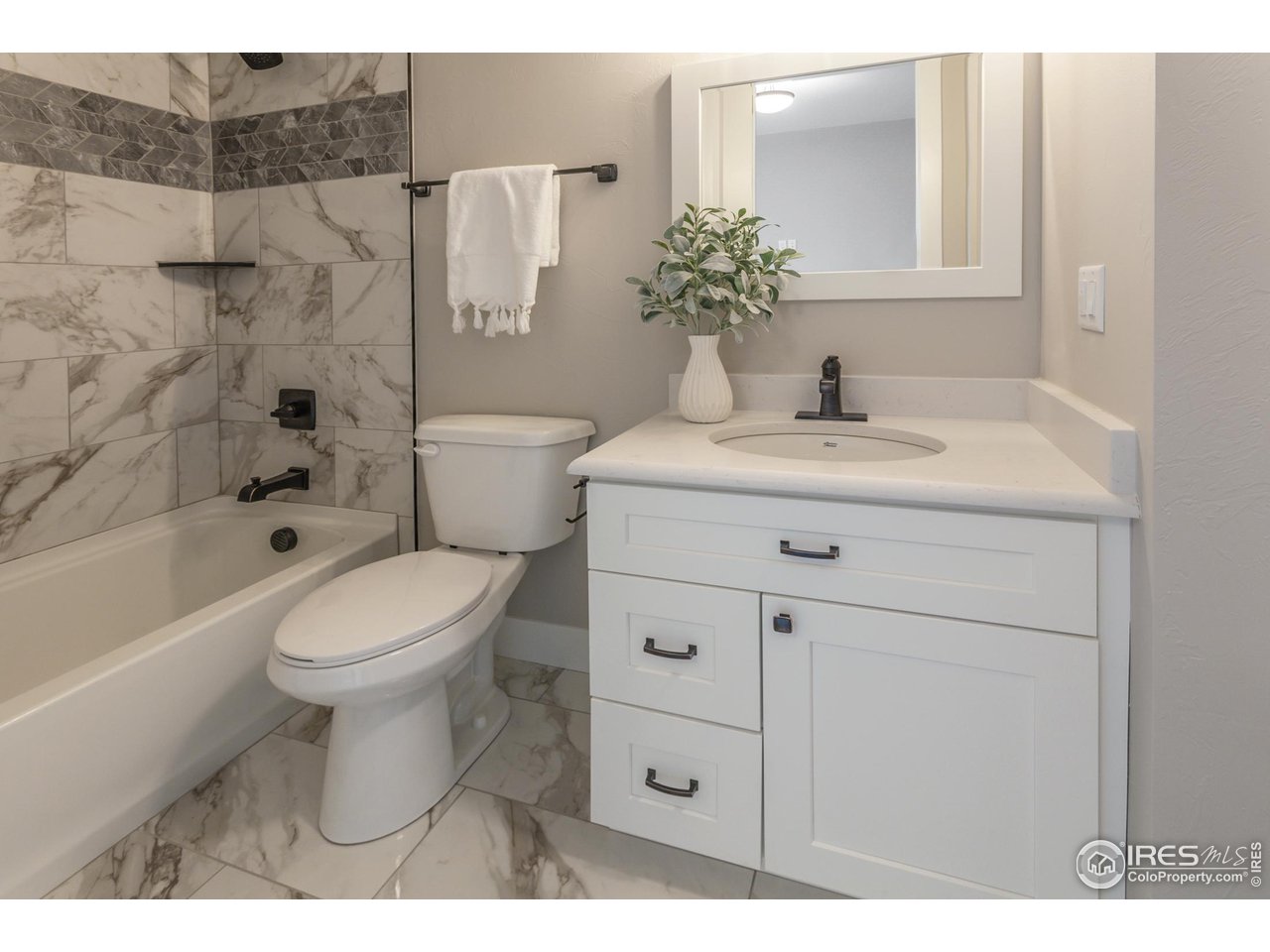 1293 Burt Avenue Berthoud, CO 80513 - Photo 22 of 40 a bathroom with a sink toilet and shower