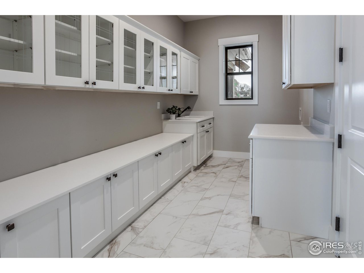 1293 Burt Avenue Berthoud, CO 80513 - Photo 24 of 40 a kitchen with cabinets and window