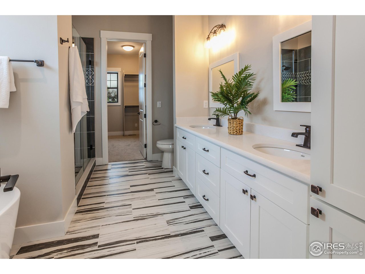 1293 Burt Avenue Berthoud, CO 80513 - Photo 27 of 40 a bathroom with a sink and a mirror